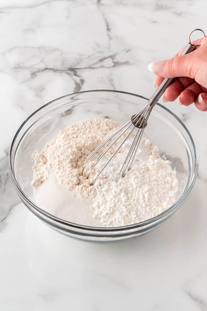 whisking dry ingredients to make crispy waffles