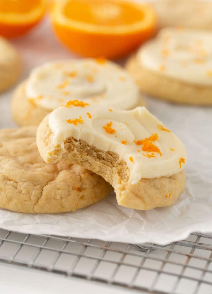 frosted orange sugar cookies on wire cooling rack