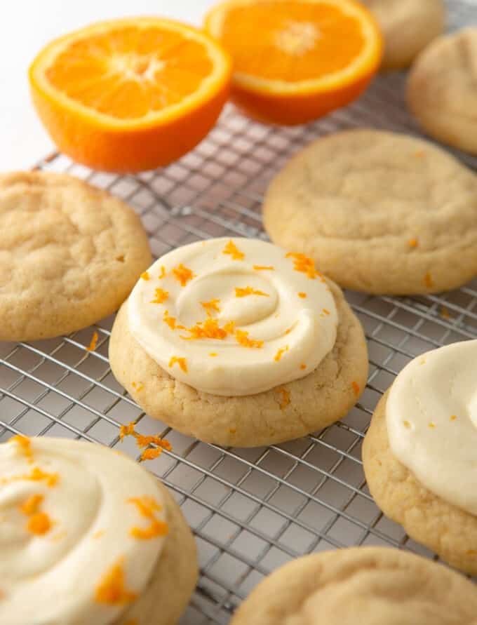 frosted orange sugar cookies on wire cooling rack