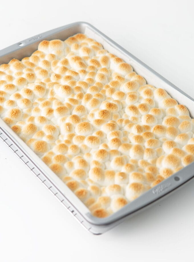 9x13 pan of s'more cookie bars with golden toasted marshmallows