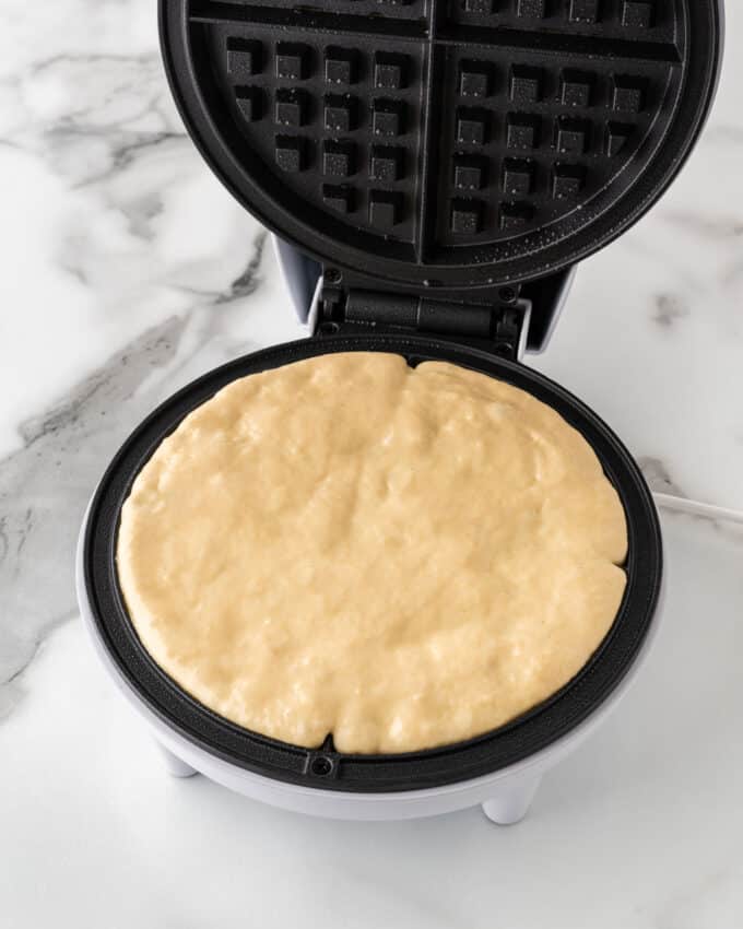 crispy waffle batter spread in waffle iron