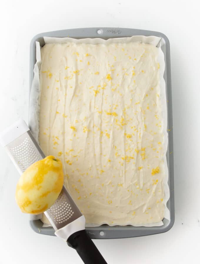 pan of no bake lemon cheesecake bars with zest on top