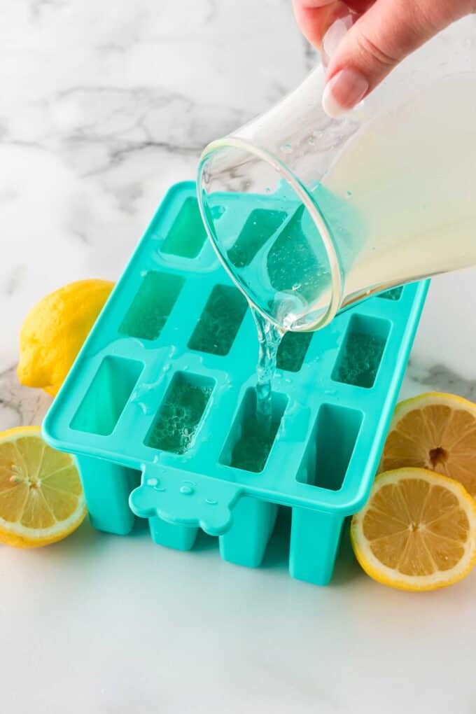 pouring lemonade into silicon popsicle mold