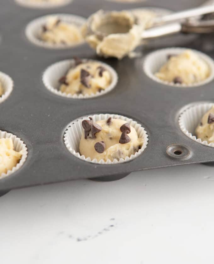 mini chocolate chip muffins in paper liner and pan
