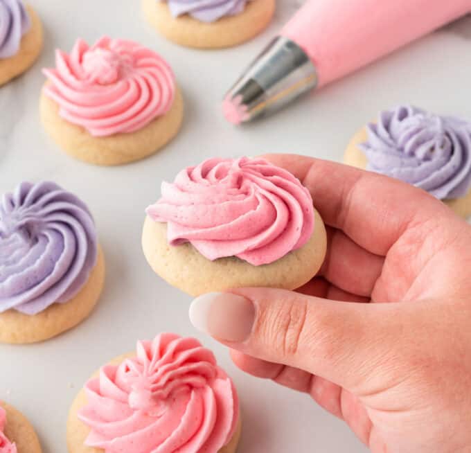 hand holding pink mini sugar cookie