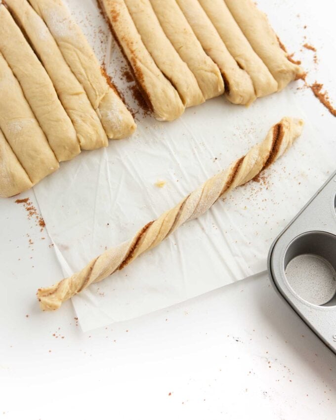 cinnamon roll dough twisted into strip