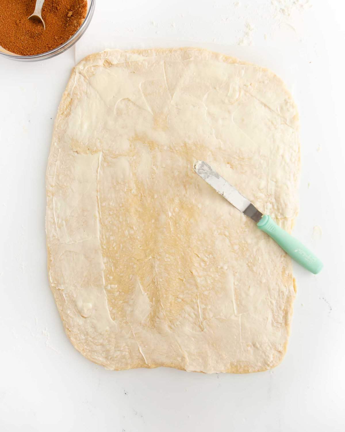 cinnamon roll dough spread with butter