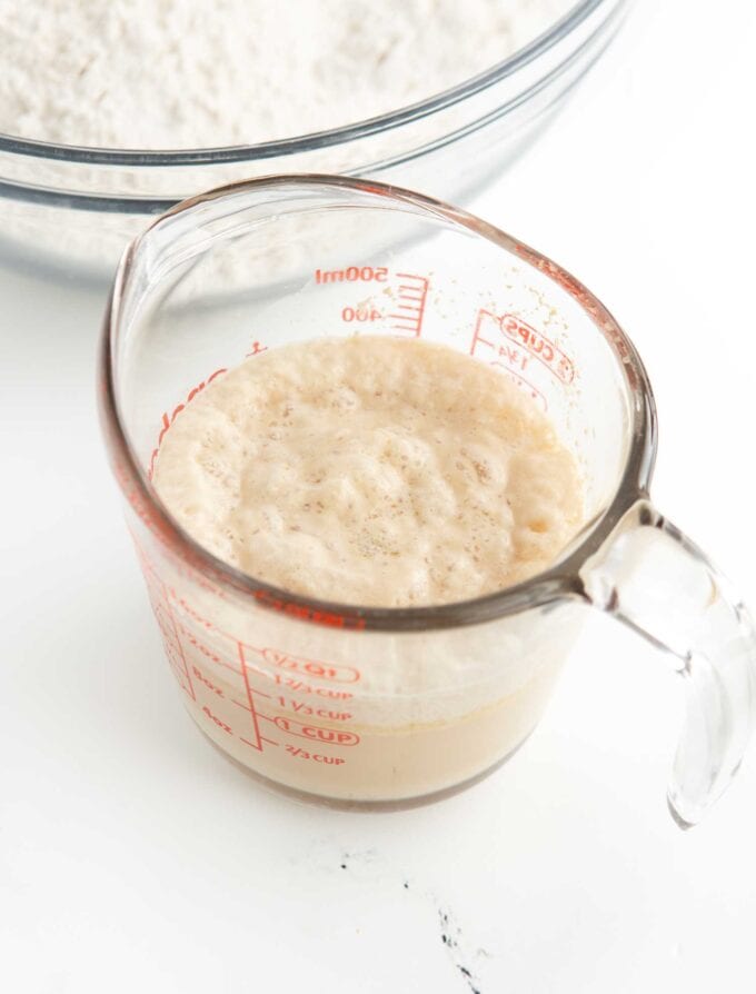 glass measuring cup of bloomed yeast