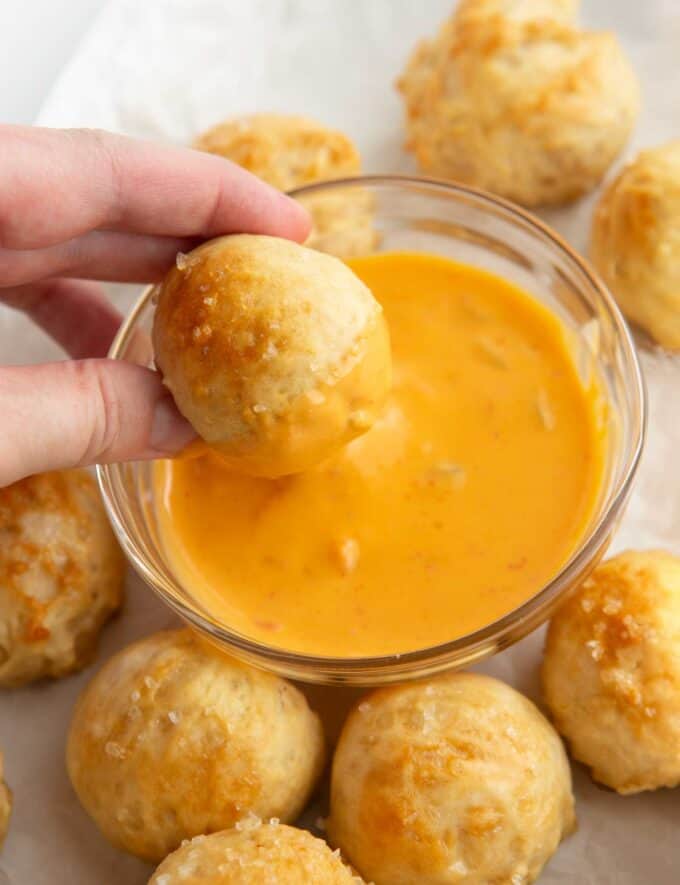 dipping pretzel bite in cheese