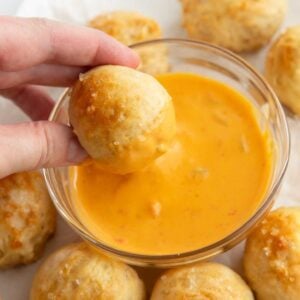 dipping pretzel bite in cheese