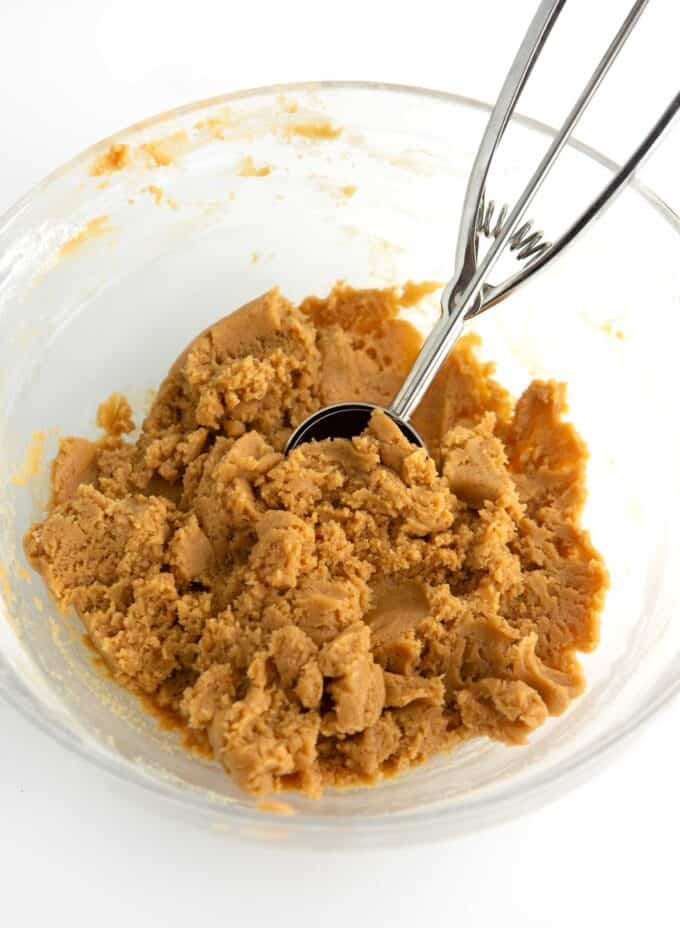 bowl of peanut butter fluffernutter cookie dough with cookie scoop