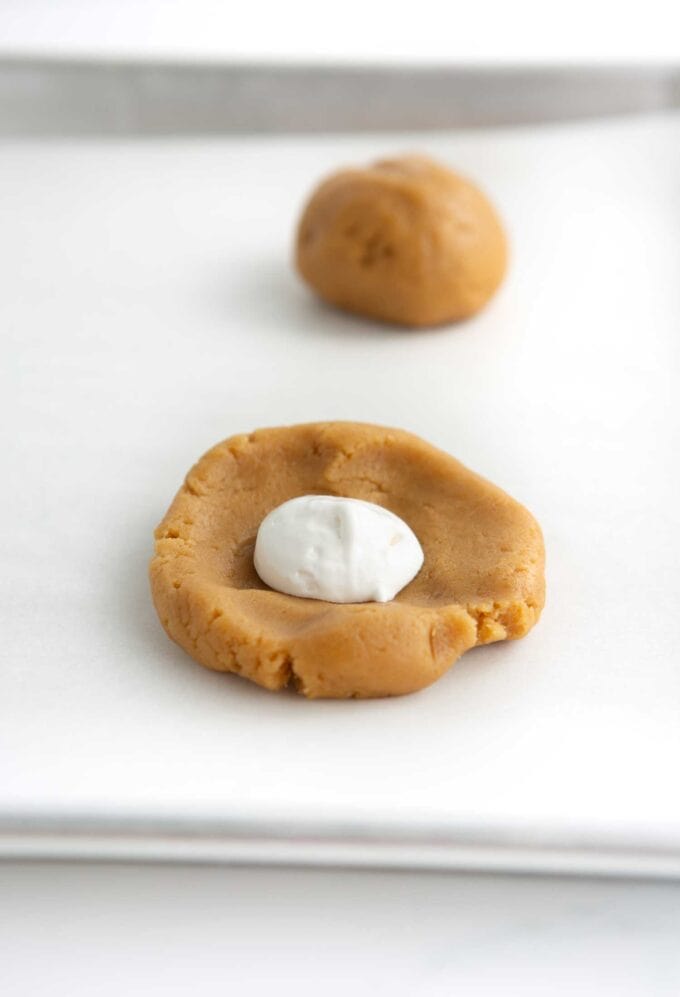marshmallow creme in the center of peanut butter cookie dough