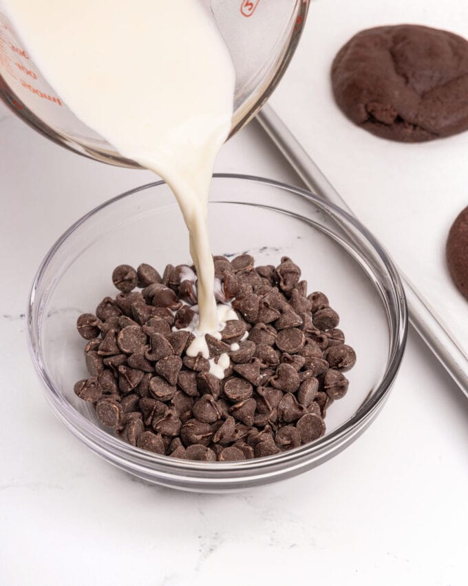 pouring heavy cream in bowl of chocolate chips