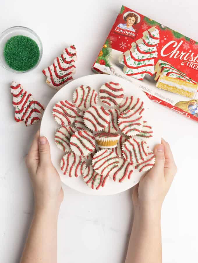 plate of cake bite cups decorated as Little Debbie Christmas tree cake