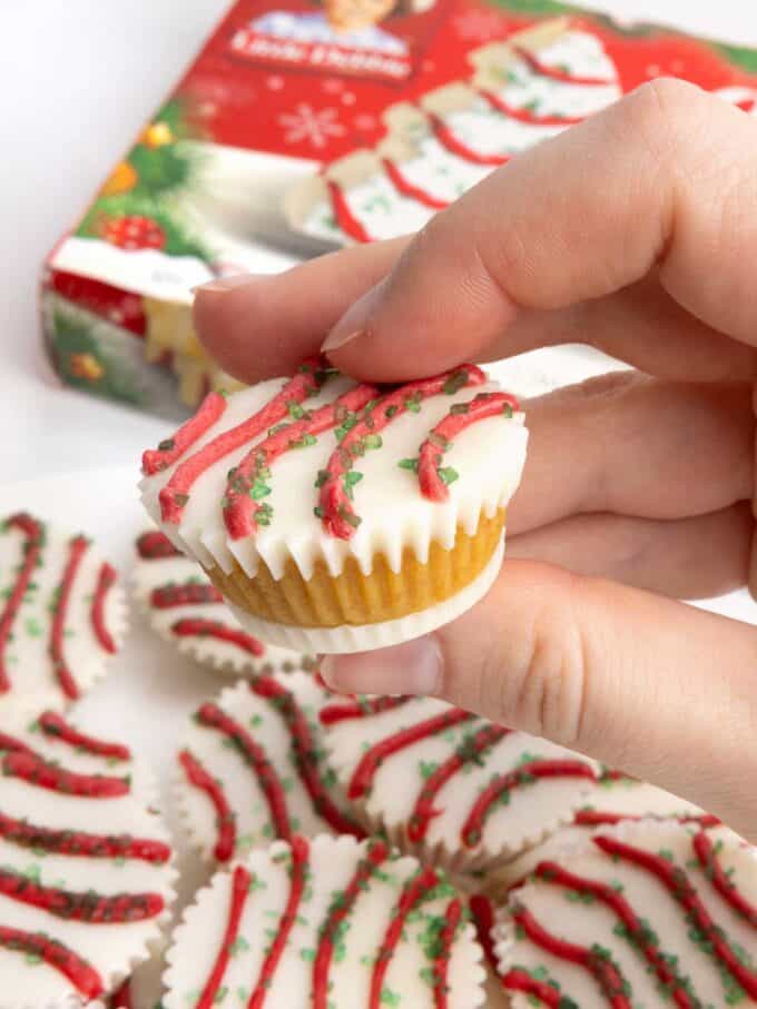 Cake ball in a mini muffin tin that does not require dipping. Decorated as Little Debbie Christmas tree cake