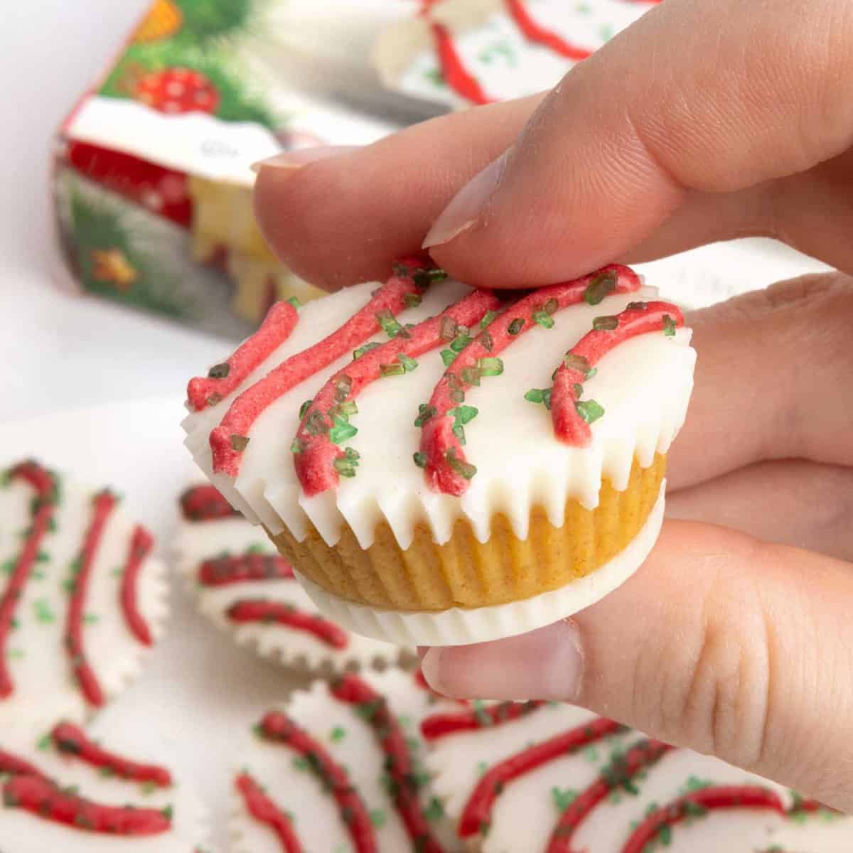 Cake ball in a mini muffin tin that does not require dipping. Decorated as Little Debbie Christmas tree cake