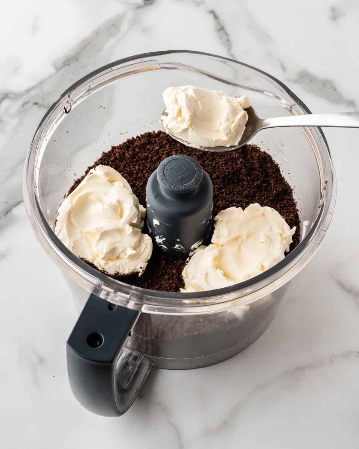 blended oreo crumbs with cream cheese in food processor