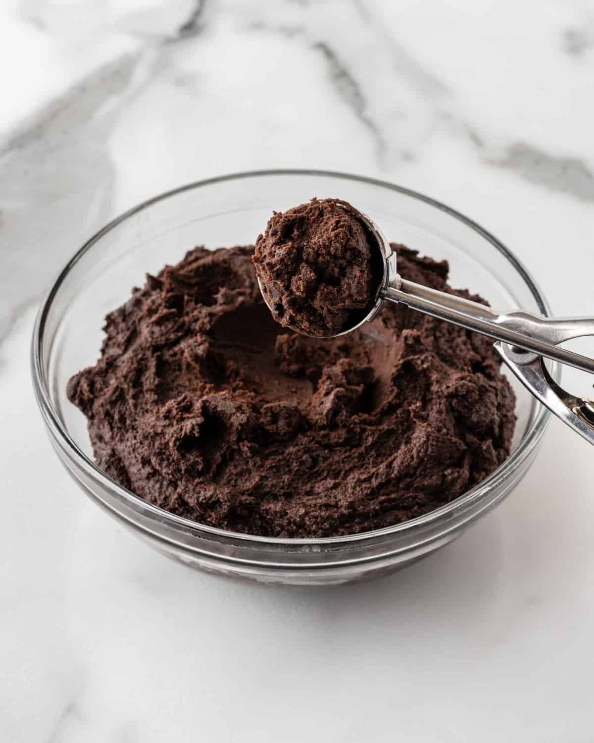 bowl of oreo truffle dough with cookie scoop