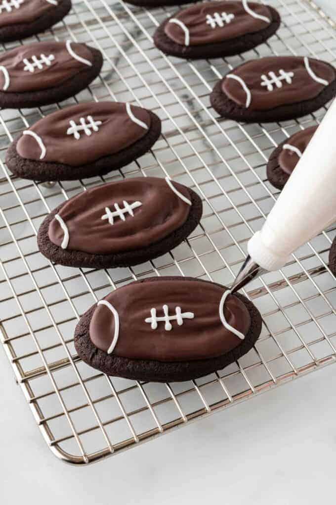 piping lace details on football cookie
