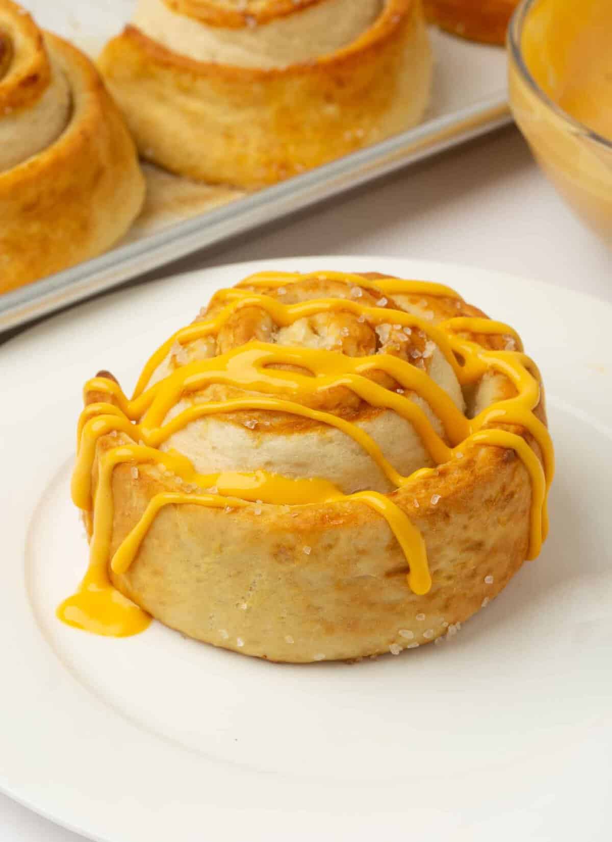 pretzel rolls with drizzled cheese sauce