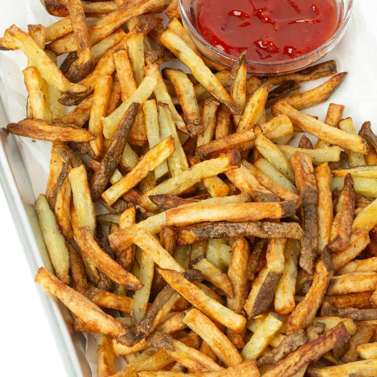 air fryer french fries on tray with bowl of ketchup