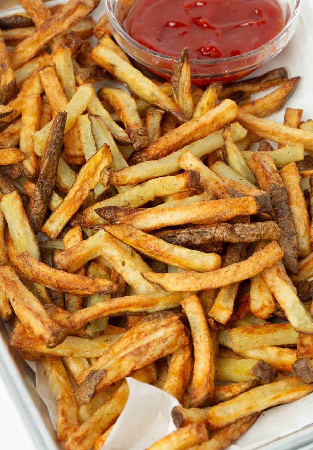 tray of air fryer french fries with small bowl of ketchup