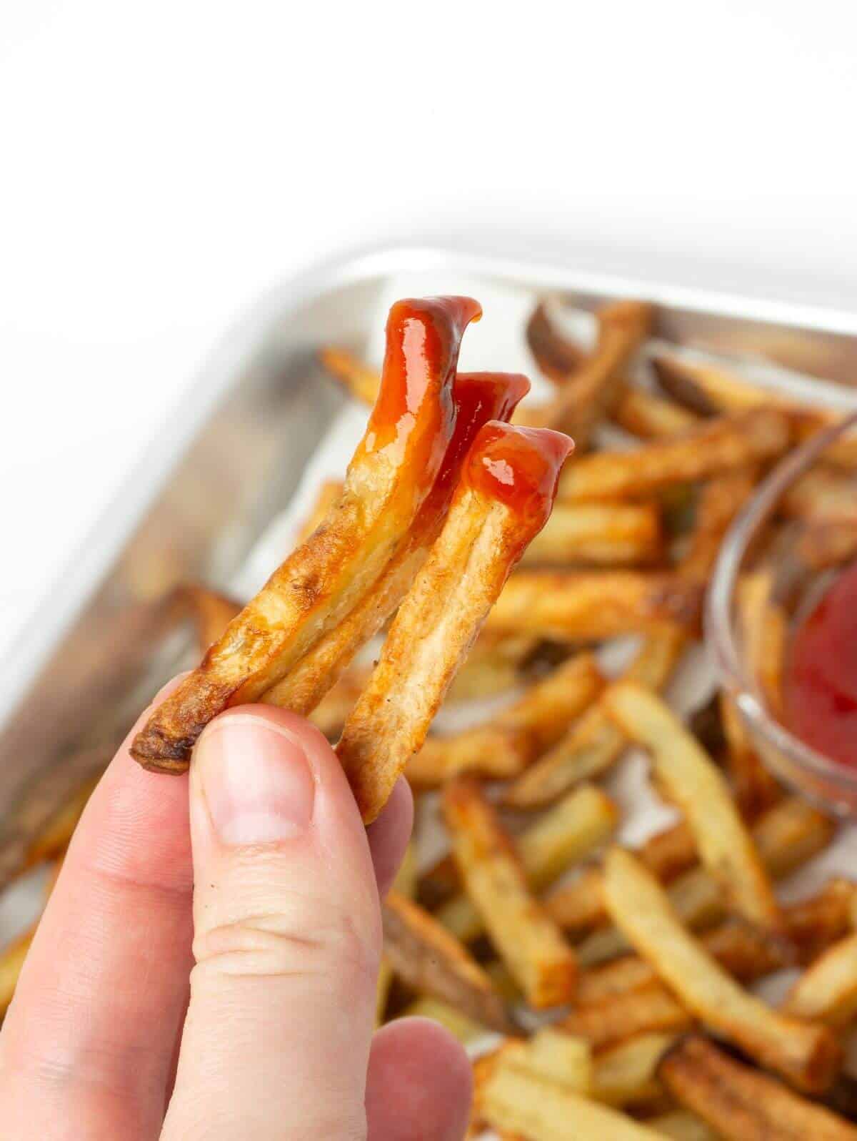air fryer french fry with dipped in ketchup