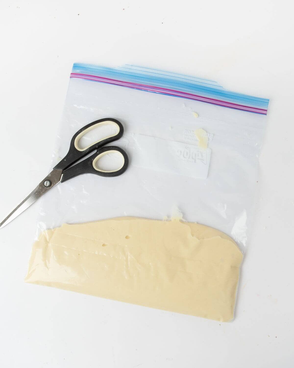 funnel cake batter in plastic bag with scissors