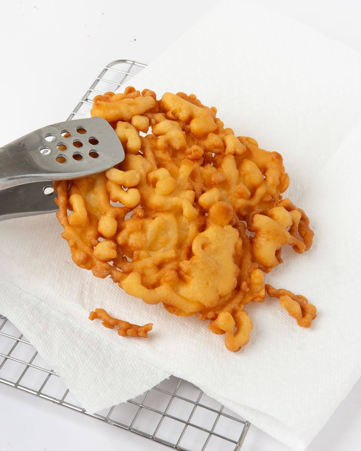 fried funnel cake on paper towel