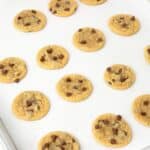 mini chocolate chip cookies on baking sheet lined with parchment paper