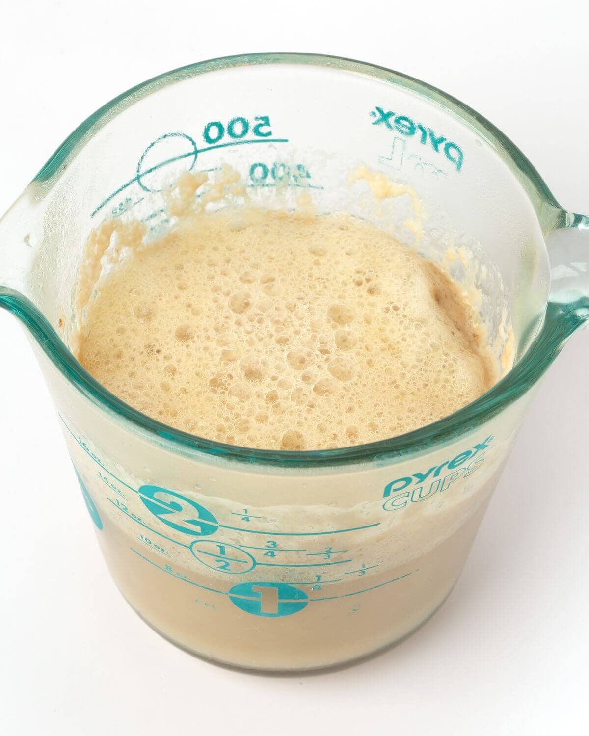 pretzel bite dough in glass measuring cup