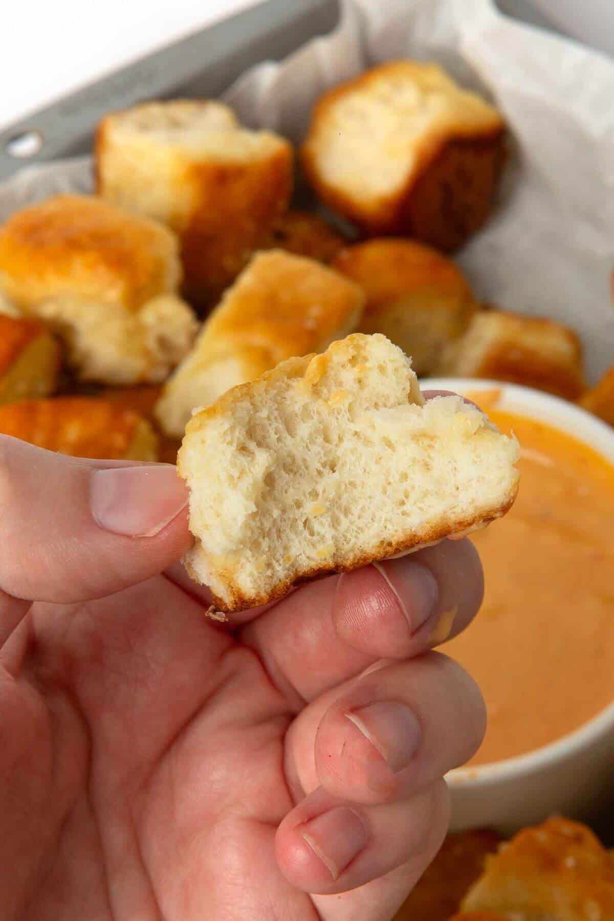 half of monkey bread pretzel bite in hand
