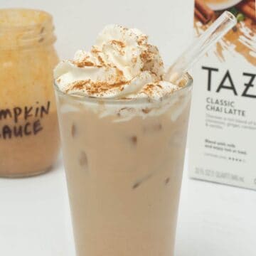 iced pumpkin cream chai in glass with straw