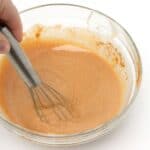 pumpkin spice sauce mixed in glass bowl with whisk