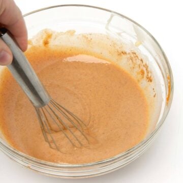 pumpkin spice sauce mixed in glass bowl with whisk