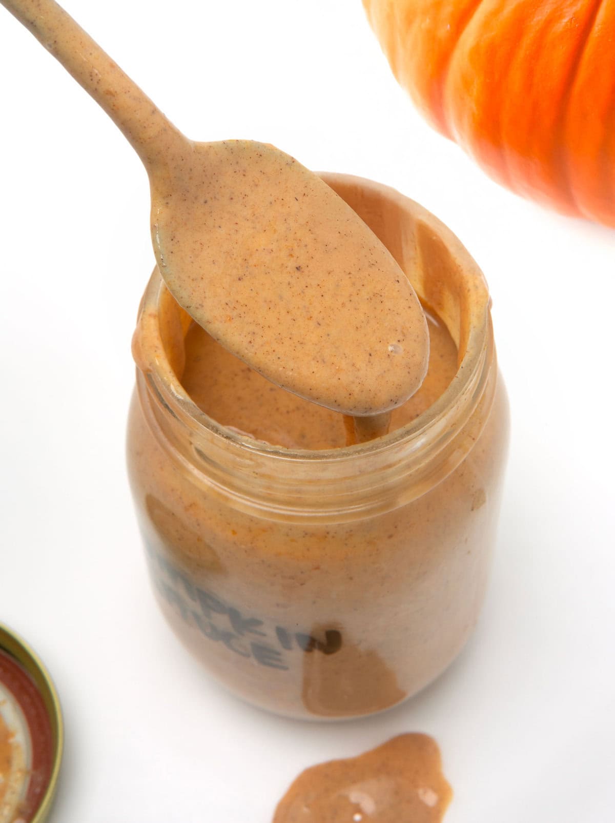 spoon of pumpkin spice sauce in jar