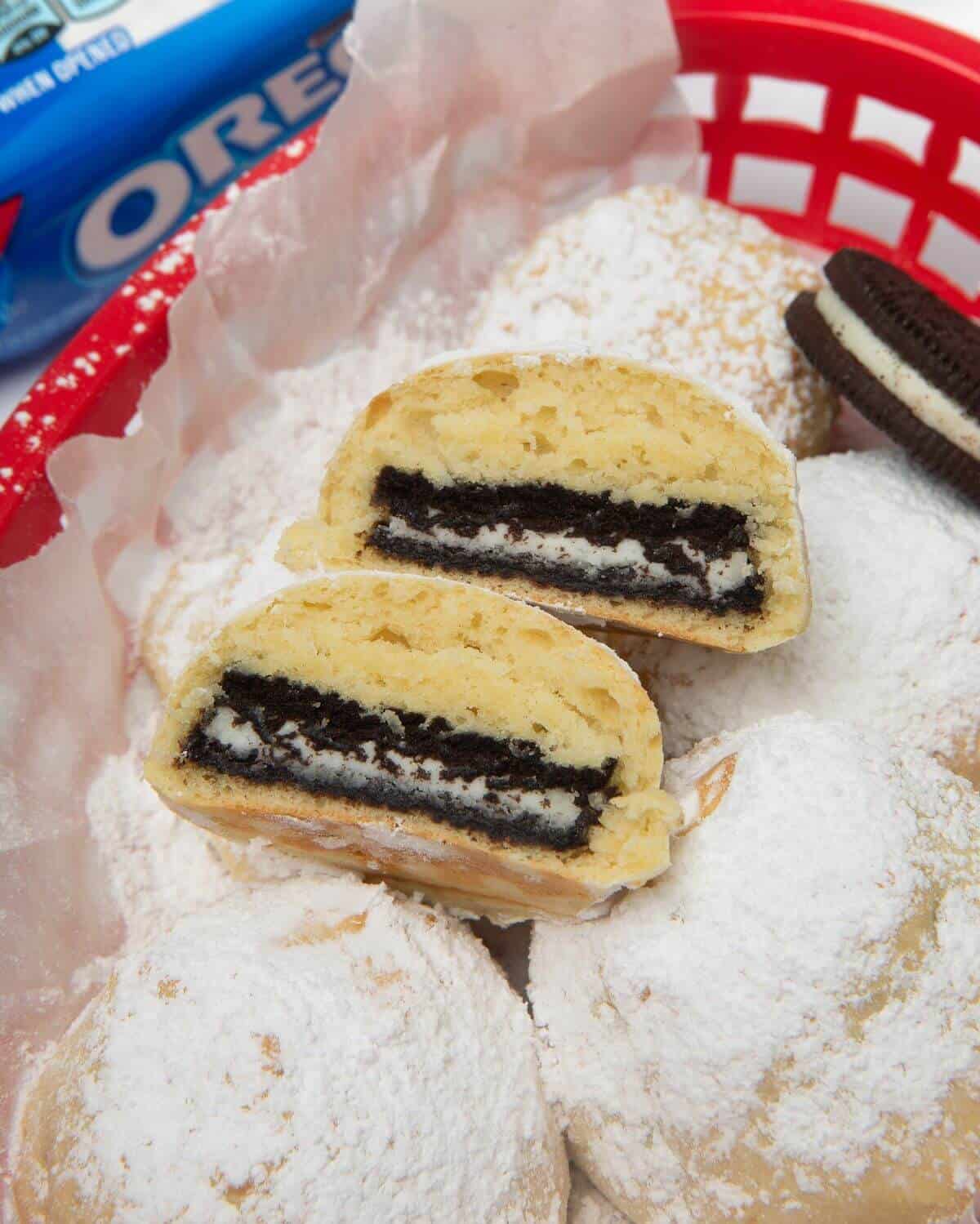 air fried oreo cut in half in red basket with powdered sugar