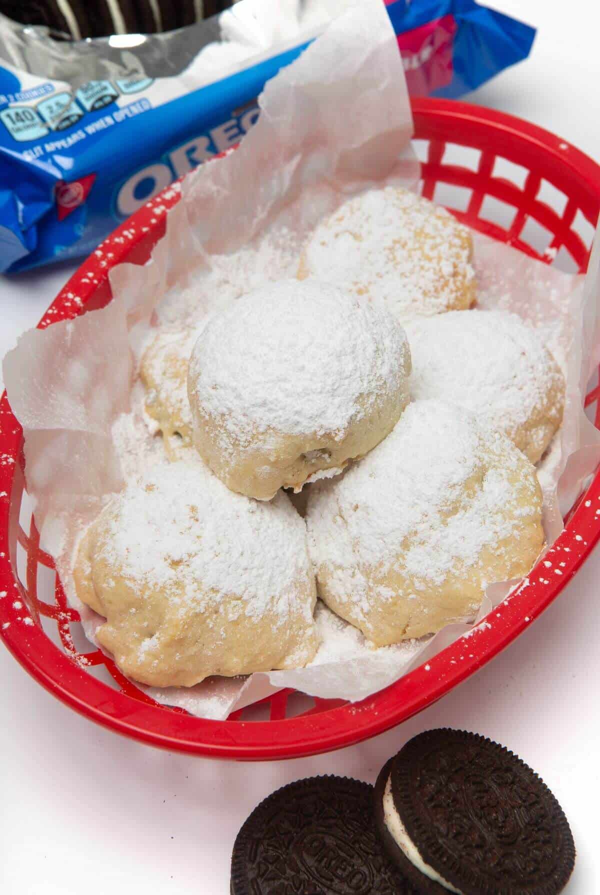 air fried oreos in red basket sprinkled with powdered sugar