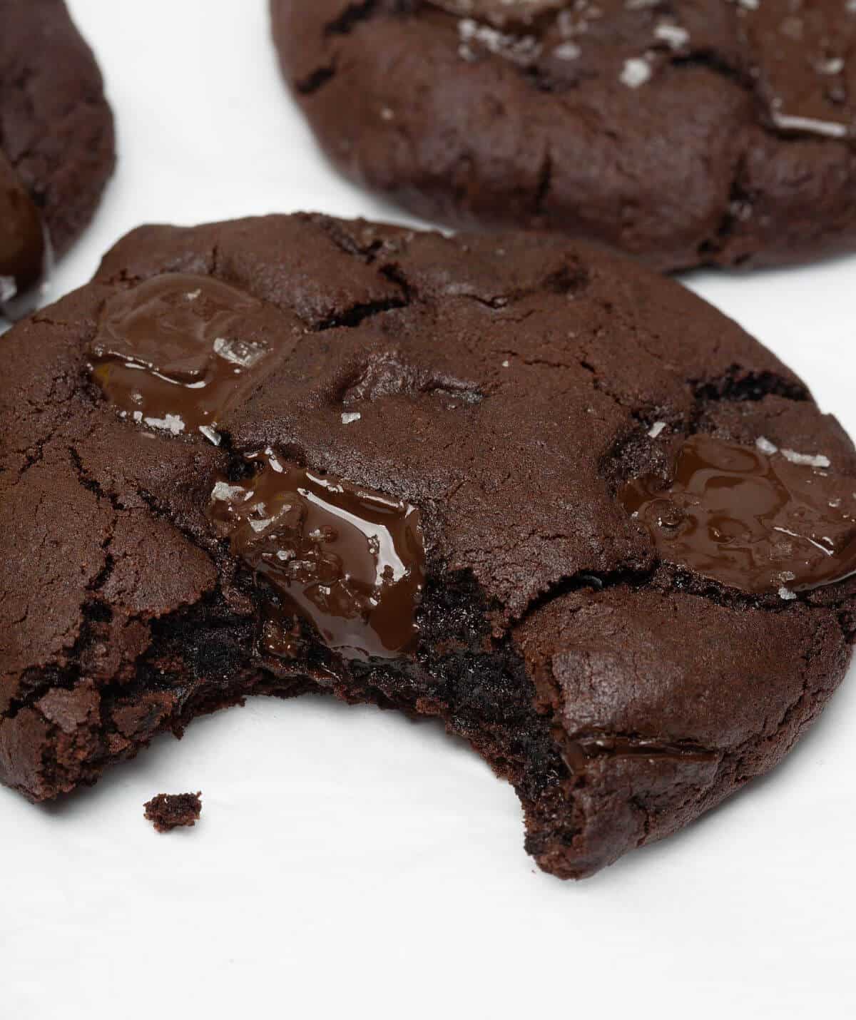 Upclose of dark chocolate cookie with bite taken out.