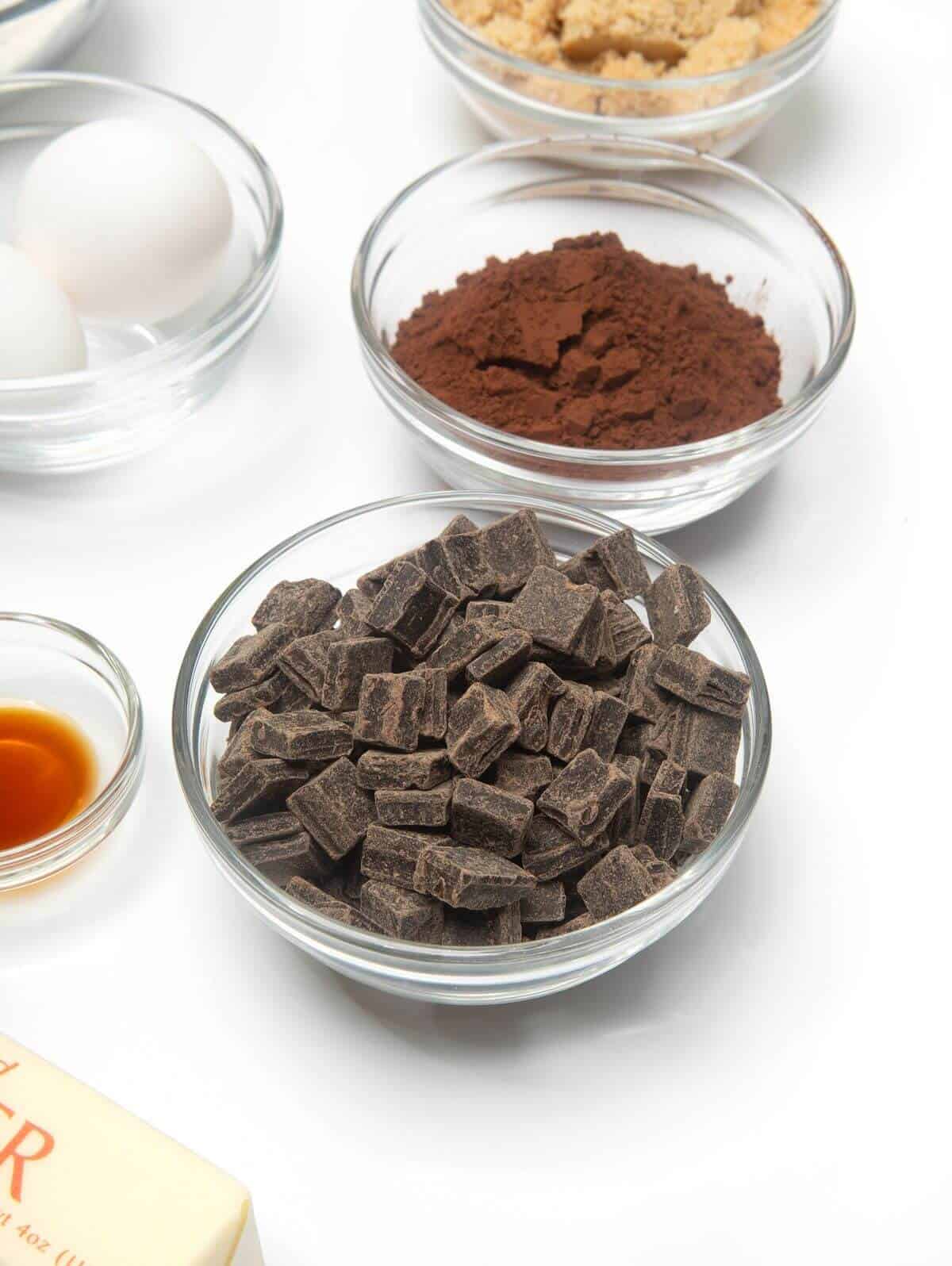 Ingredients in mini glass bowls for dark chocolate cookies.