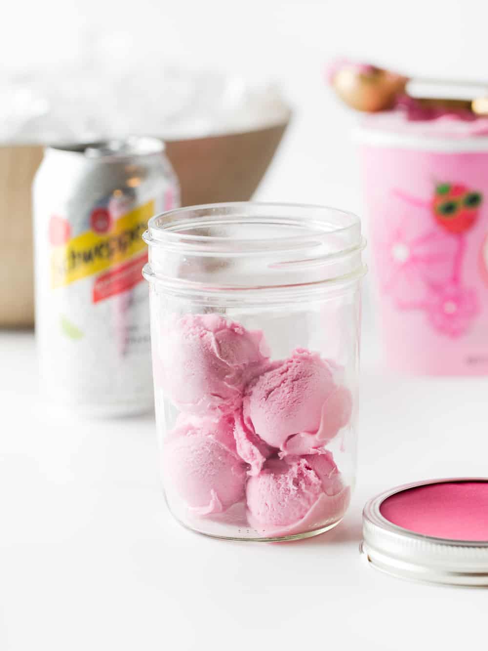 Scoops of raspberry sherbet in mason jar to make DIY punch bar.