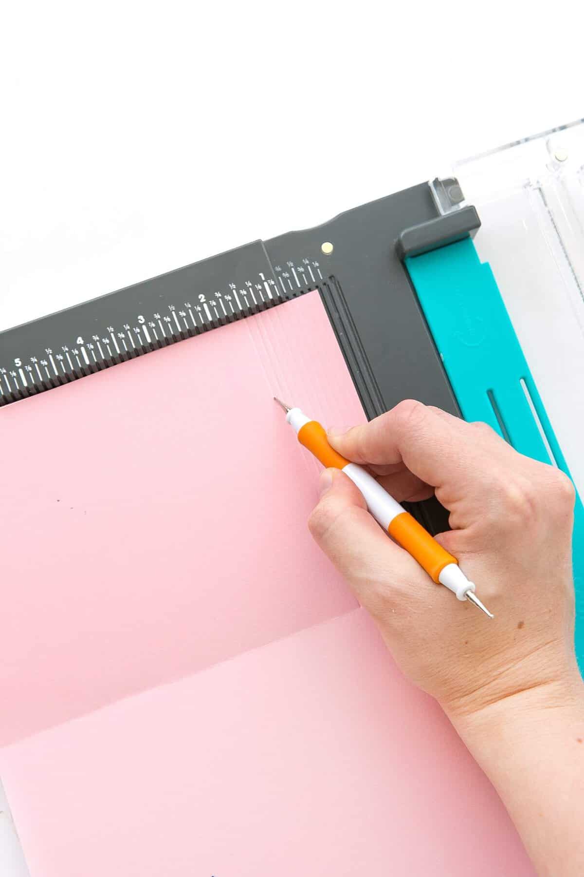 Scoreboard scoring pink cardstock with scoring tool to make Letterboard DIY Birthday Cards