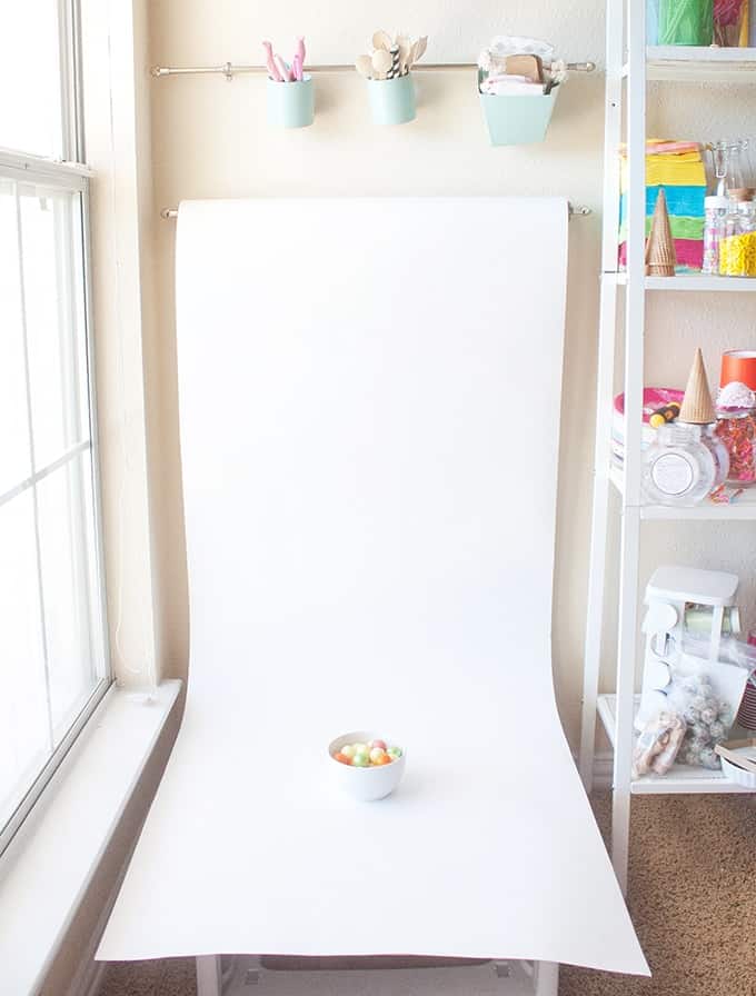 Love this idea for blog photography backgrounds! Get a large roll of white paper & hang it on a curtain rod!