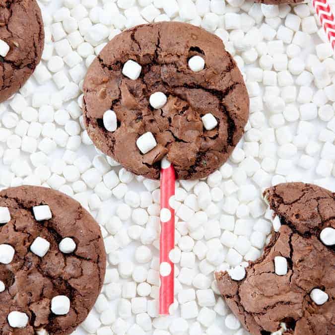 Make these Hot Chocolate Brownie Cookie Pops using a boxed brownie mix & one cup of chocolate cake mix! The cake mix makes them thick, while still keeping a chewy, chocolately texture! Fun way to use those mini marshallows! Love this idea!
