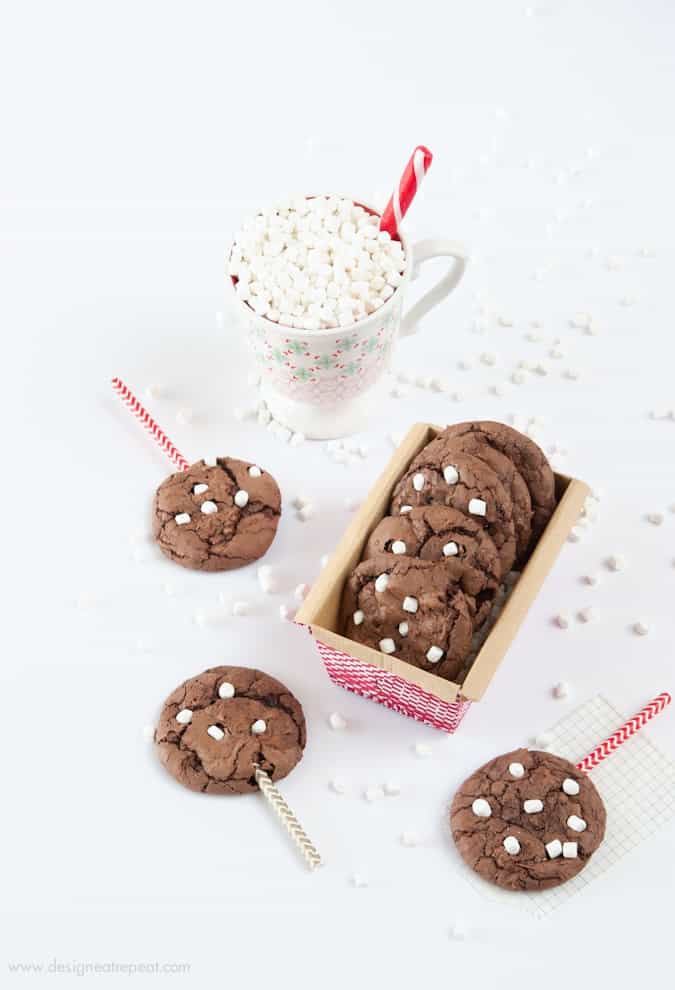 Make these Hot Chocolate Brownie Cookies using a boxed brownie mix & one cup of chocolate cake mix! The cake mix makes them thick, while still keeping a chewy, chocolately texture! Fun way to use those mini marshallows! Recipe by Design Eat Repeat