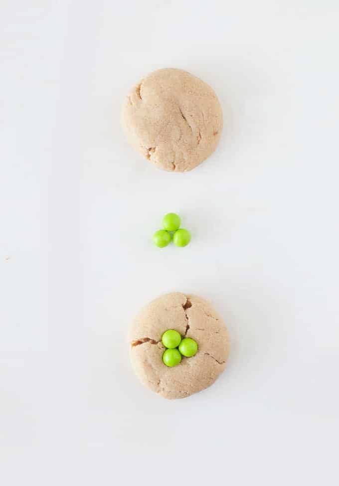Peanut Butter Shamrock Cookies | Transform a normal peanut butter cookie into a St. Patrick's Day treat by popping 3 green Sixlets on top!