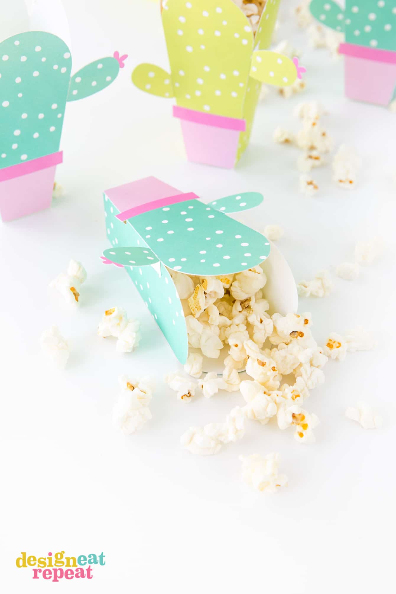 Can these be any cuter?! Cactus popcorn boxes! Get the free popcorn box template at DesignEatRepeat.com | #printable #popcornbox