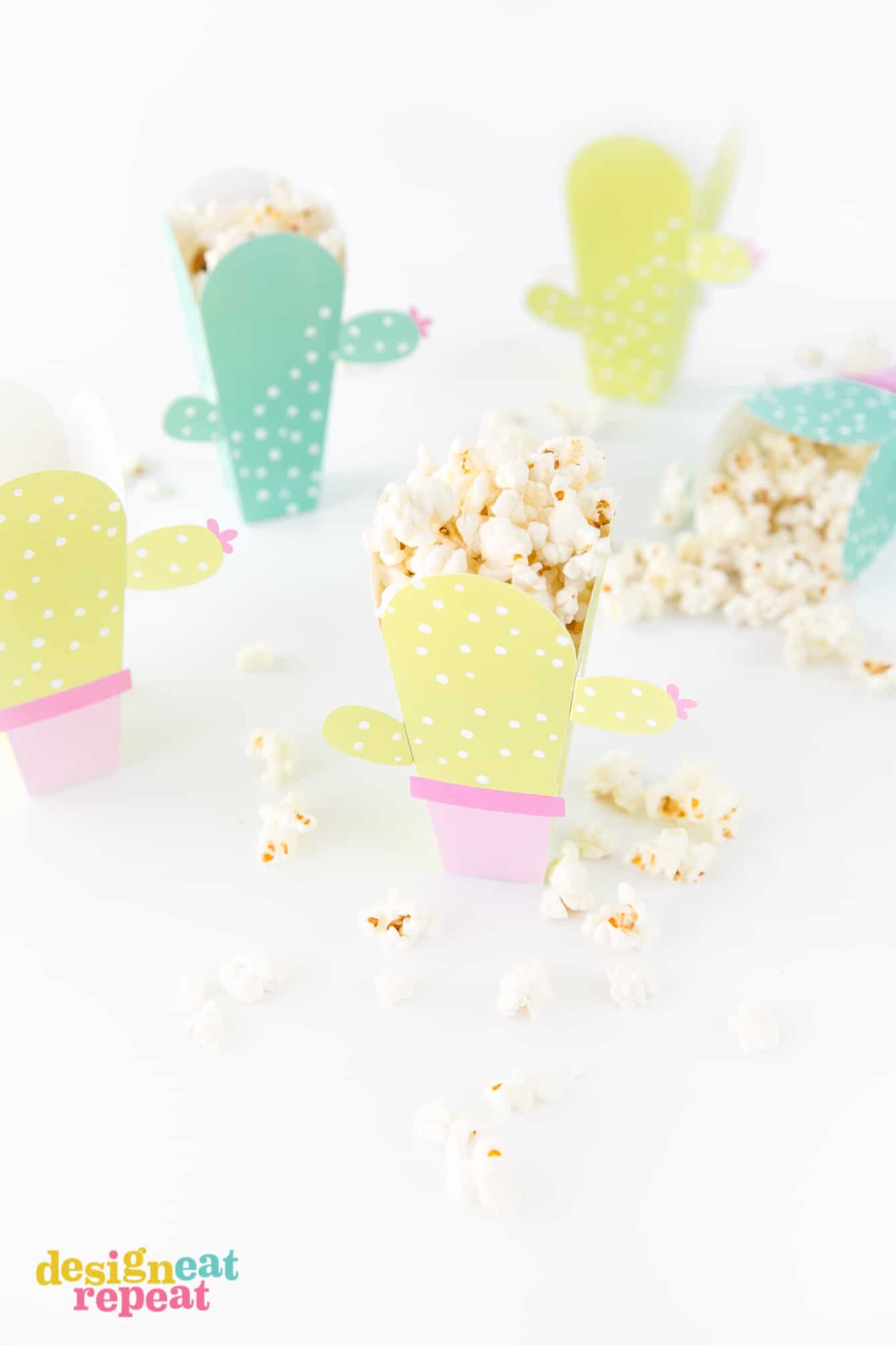 Can these be any cuter?! Cactus popcorn boxes! Get the free popcorn box template at DesignEatRepeat.com | #printable #popcornbox