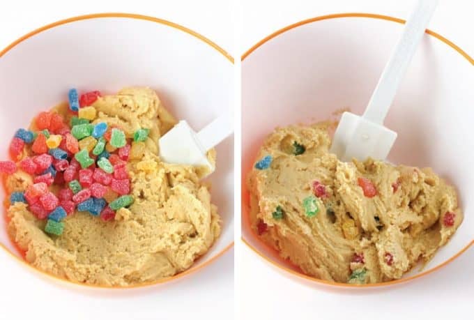 Adding sour patch kids candy to cookie dough and mixing with spatula to make sour patch kids cookies.