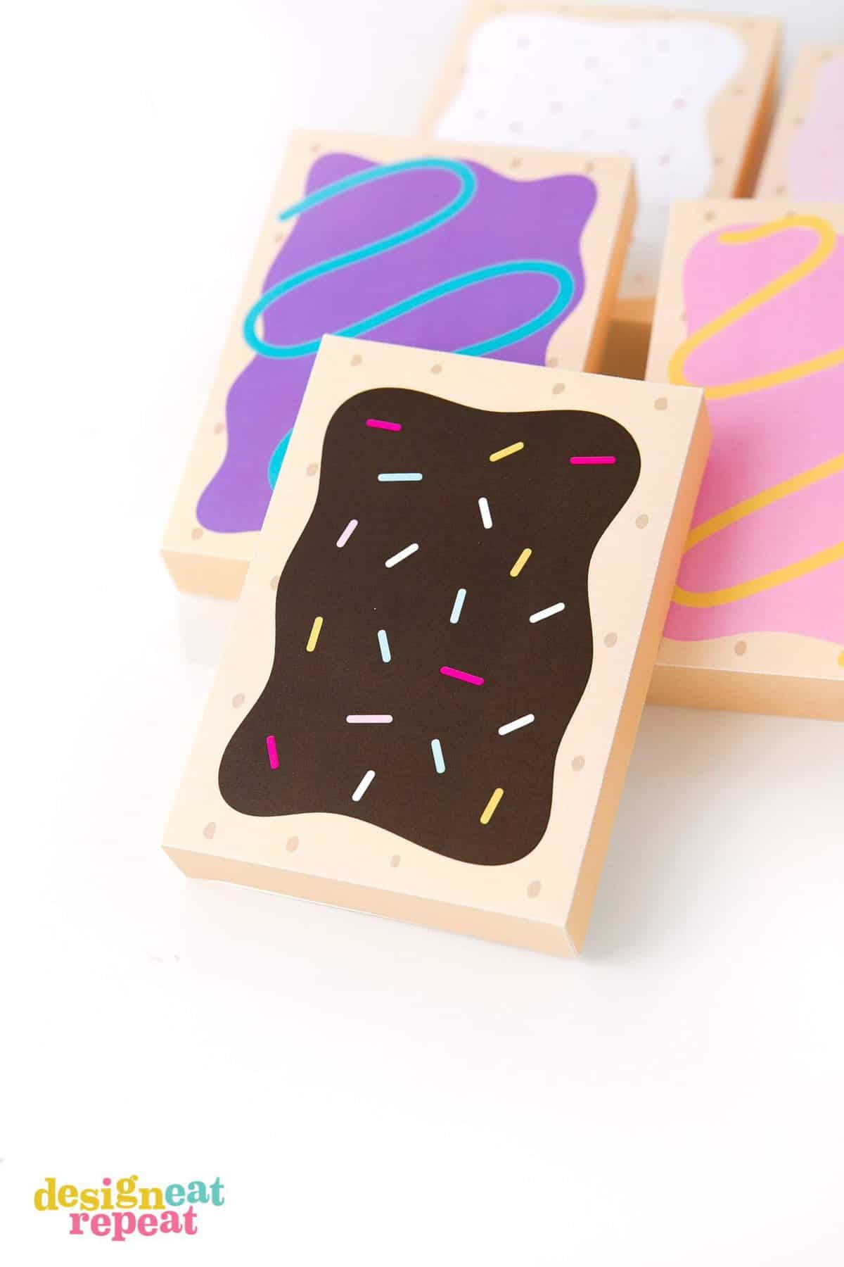 How fun are these?! Printable POP-TART treat boxes! With 8 delectable designs, these gift box templates are sure to please your party goers with their flavor of choice! Download at DesignEatRepeat.com | #printable #silhouette